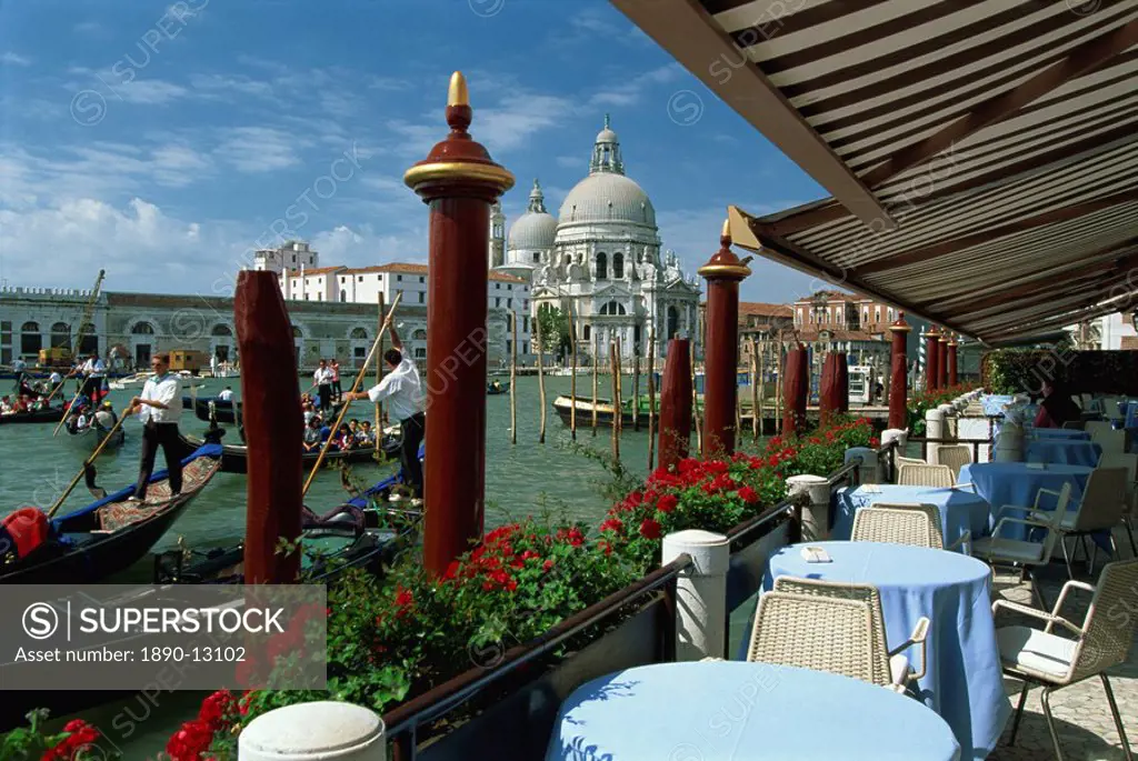 Outdoor restaurant beside the Grand Canal, opposite the Church of Santa Maria della Salute, Venice, UNESCO World Heritage Site, Veneto, Italy, Europe