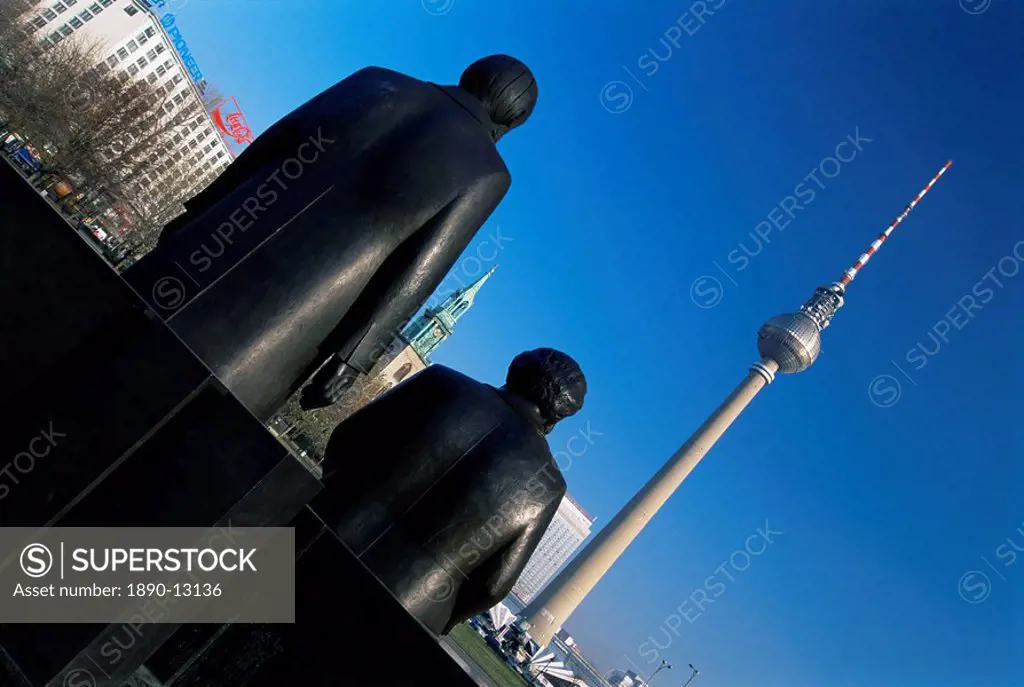 Statues of Marx and Engels, with TV Tower or Fernsehturm beyond, Berlin, Germany, Europe