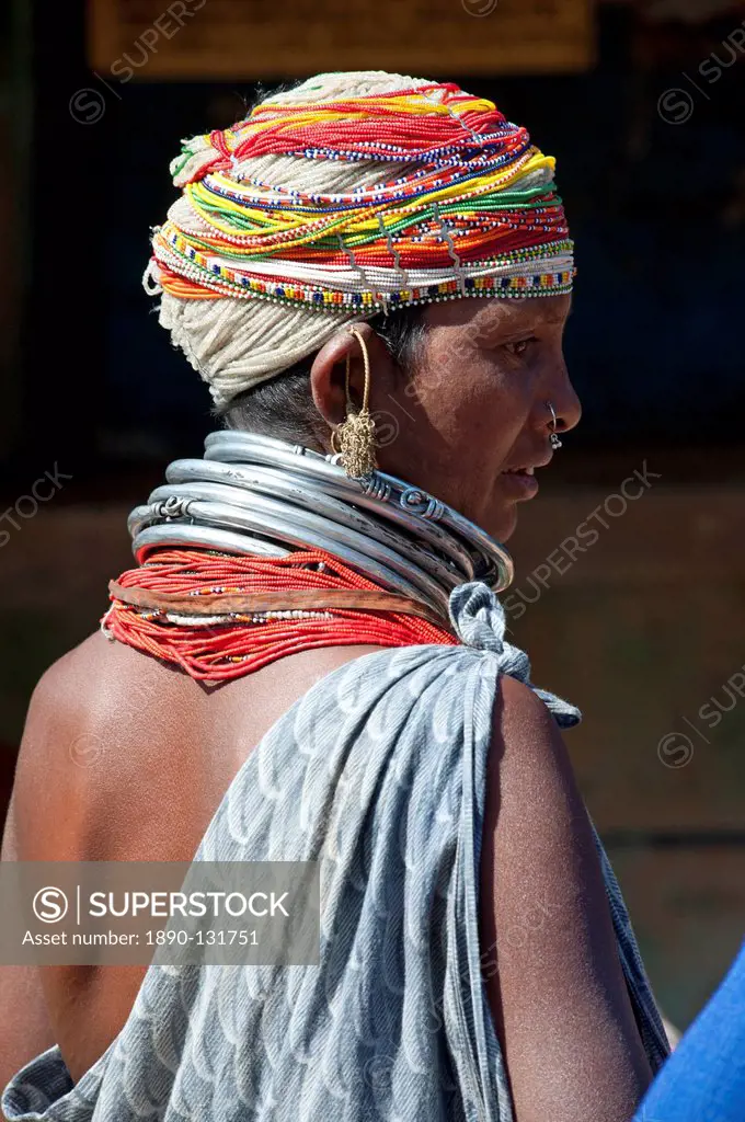 Bonda tribeswoman wearing grey blue cotton shawl and beads with beaded cap, large earrings and metal necklaces at weekly market, Rayagader, Orissa, In...