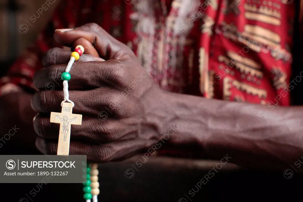 African man praying the rosary, Cotonou, Benin, West Africa, Africa