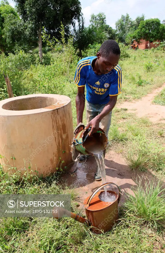 Man fetching water from well, Tori, Benin, West Africa, Africa