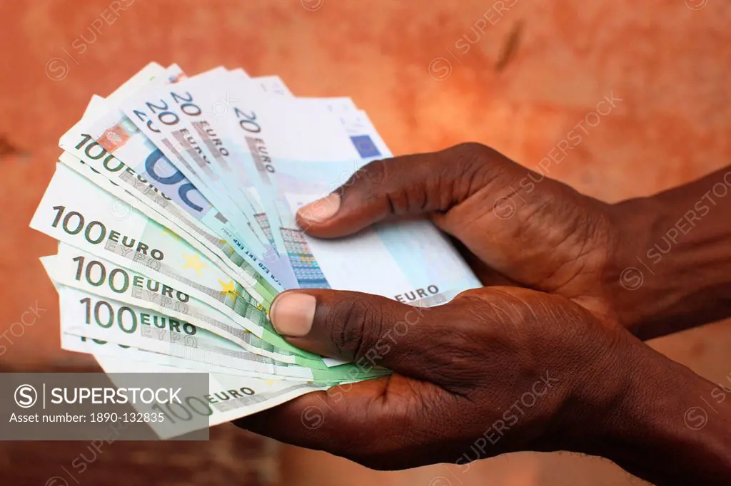 African holding Euros, Lome, Togo, West Africa, Africa