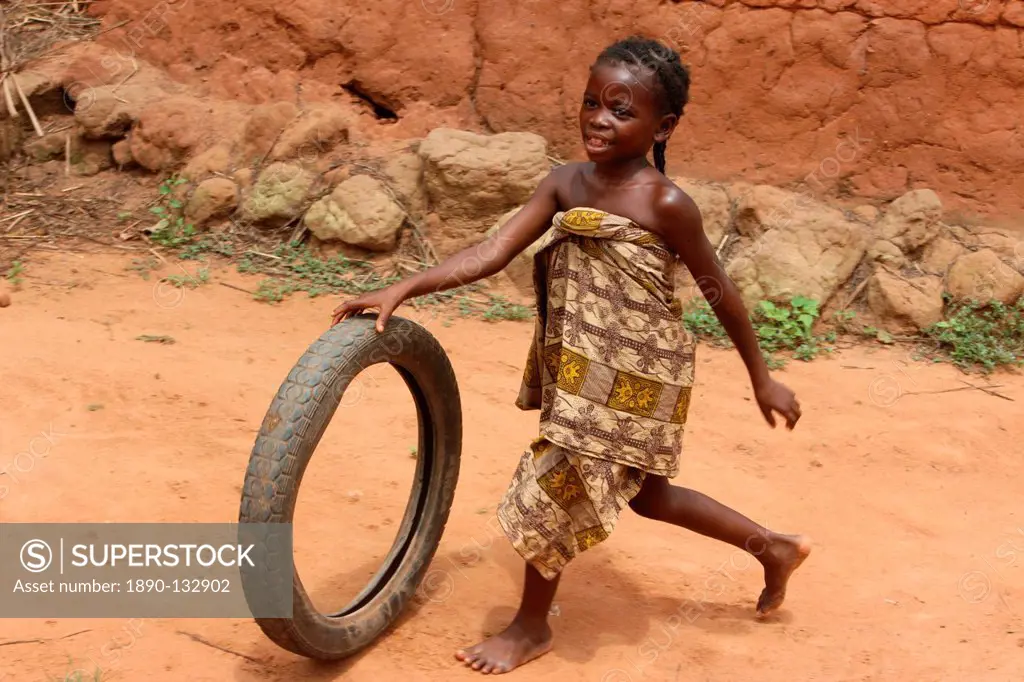 Child playing with a tyre, Tori, Benin, West Africa, Africa