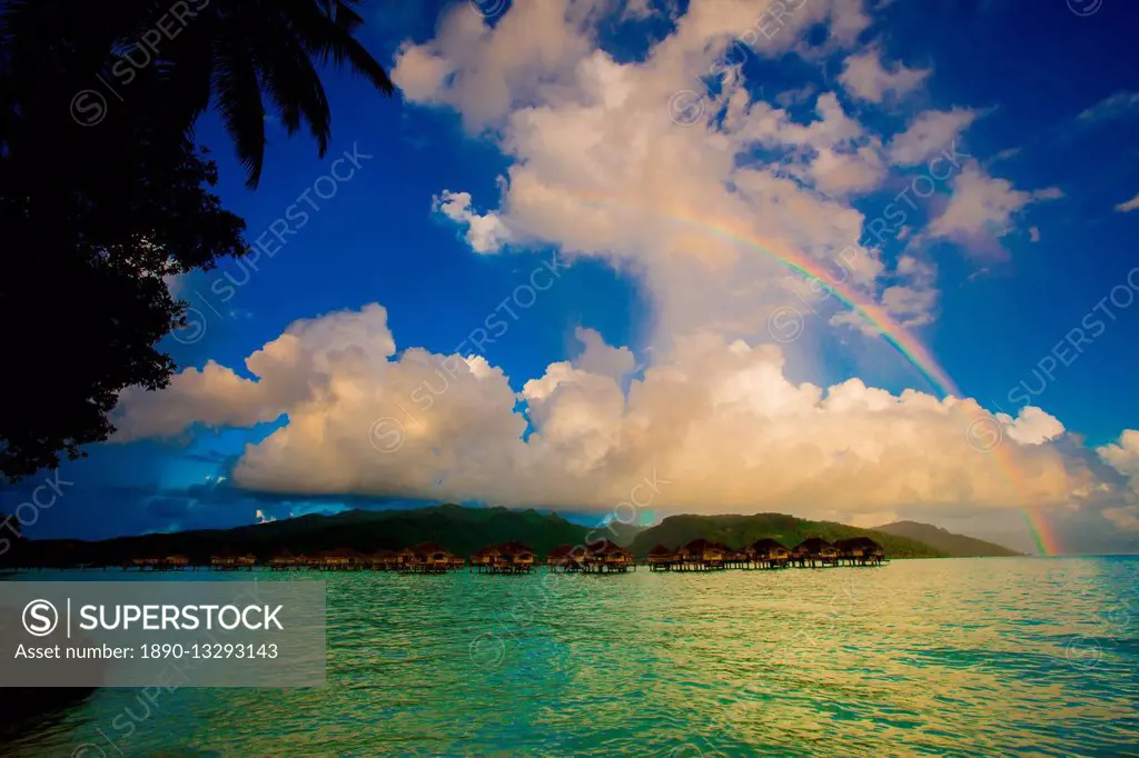 Rainbow arcing over the overwater bungalows, Le Taha'a Resort, Tahiti, French Polynesia, South Pacific, Pacific