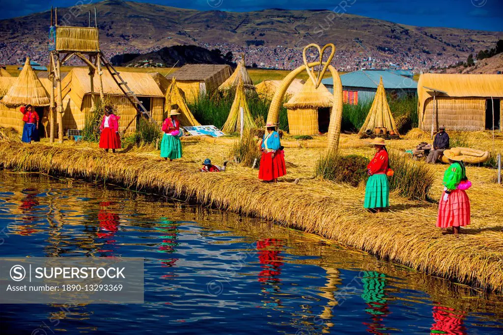 Quechua Indian family on Floating Grass islands of Uros, Lake Titicaca, Peru, South America