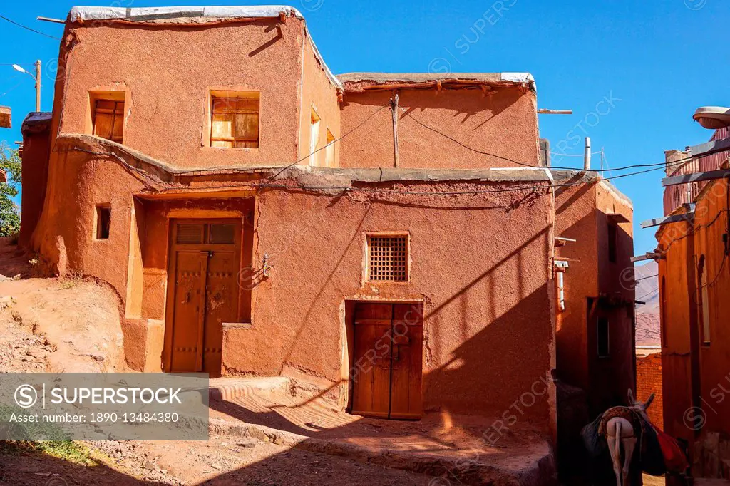 Winding lanes and donkey in 1500 year old traditional village of red mud brick houses, Abyaneh, Iran, Middle East