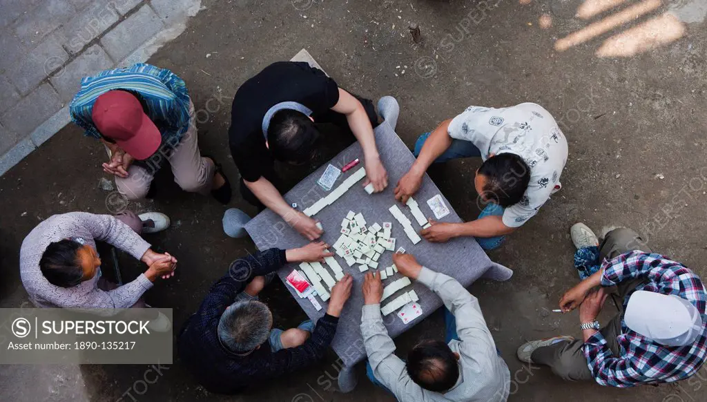Overhead view of Chinese men sitting outdoors playing the traditional game of mahjong, Hangzhou, China, Asia