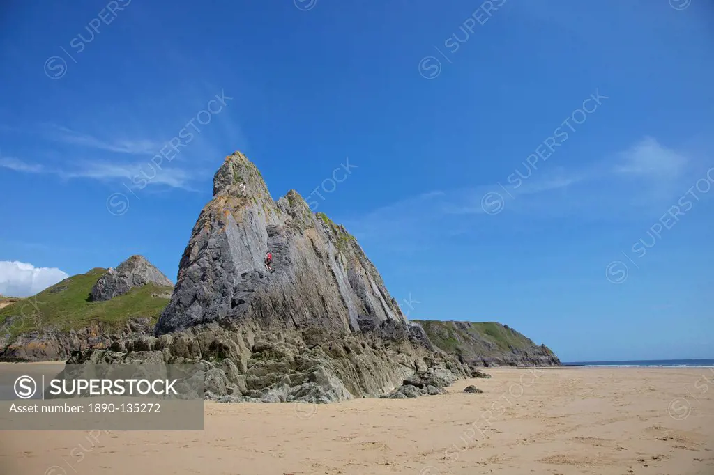 Two rock climbers on the Three Cliffs beach in spring morning sunshine, Gower Peninsula, County of Swansea, Wales, United Kingdom, Europe