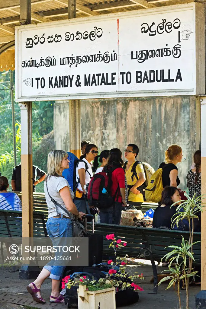 Foreign travellers await the popular Colombo to Badulla train at the railway station at Peradeniya, near Kandy, Sri Lanka, Asia