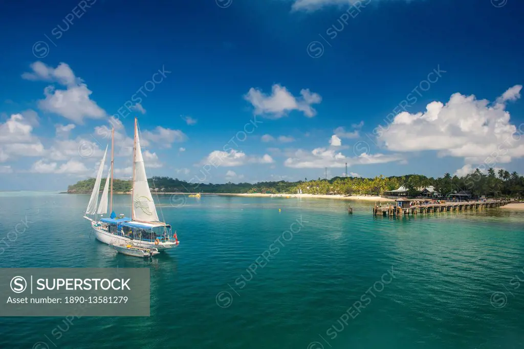 Sailing boat anchoring on Mana Island, Mamanuca Islands, Fiji, South Pacific