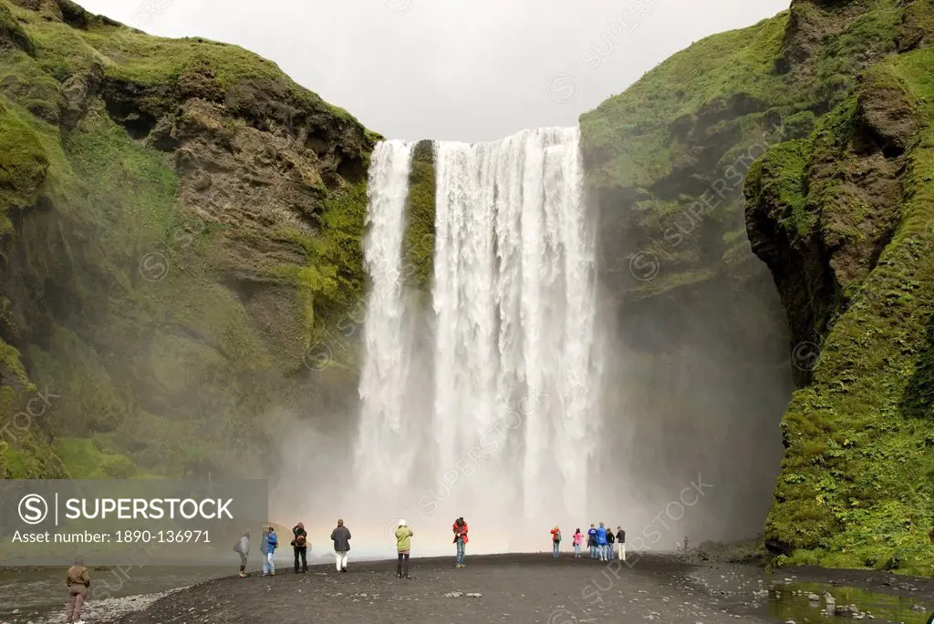 Skogarfoss, the powerful curtain waterfall drops 60 m over a cliff of basalt lavas, south coast, Iceland, Polar Regions