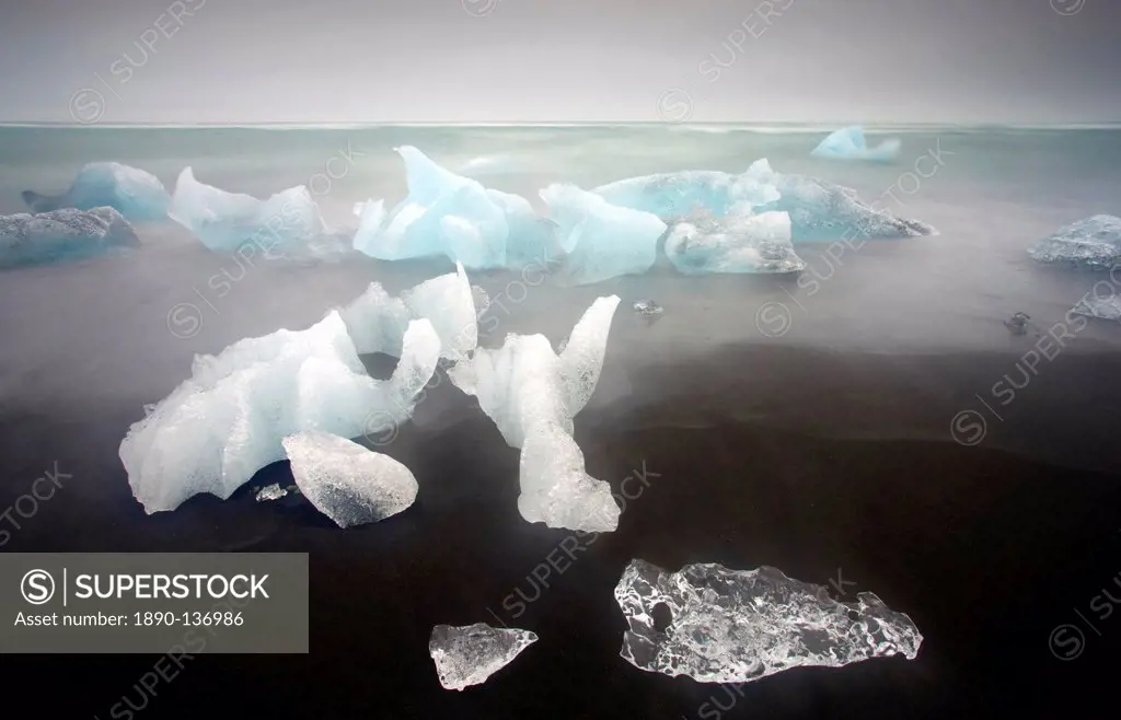 Icebergs from the Jokulsarlon glacial lagoon washed up on a nearby black volcanic sand beach from the North Atlantic Ocean, Iceland, Polar Regions
