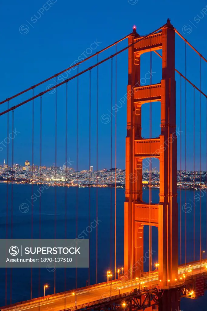 The Golden Gate Bridge, linking the city of San Francisco with Marin County, taken from the Marin Headlands at night with the city in the background a...