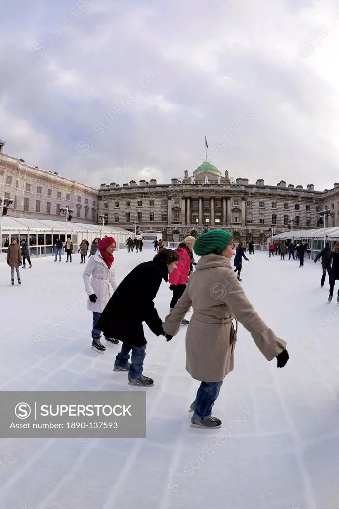 Skaters skating on outside ice rink, Somerset House, London, England, United Kingdom, Europe