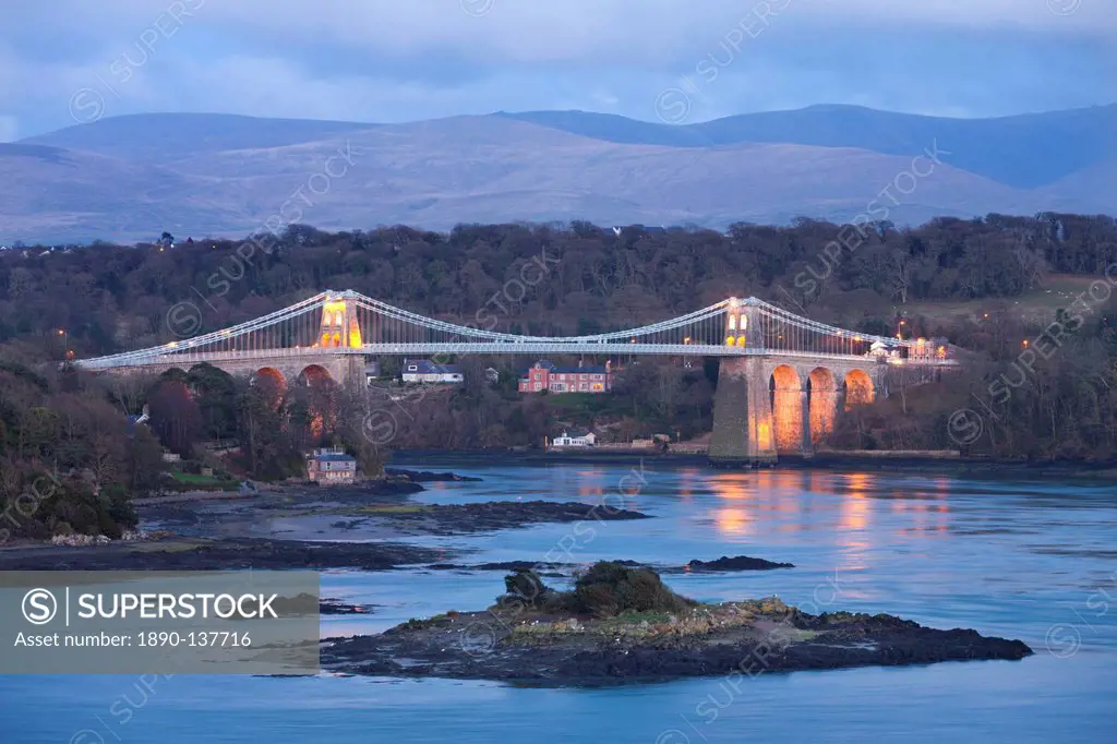 The Menai Bridge spanning the Menai Strait, backed by the mountains of Snowdonia National Park, Wales, United Kingdom, Europe