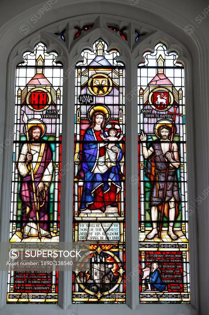 Stained glass window by Lawrence Lee showing the Virgin Mary and Child flanked by St. Thomas and St. John the Baptist with a roundel of the church tow...