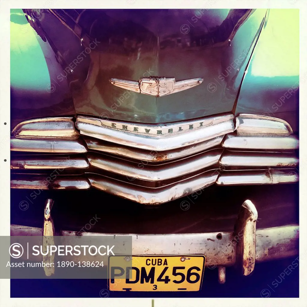 Detail of the front of an old green Chevrelet showing the chrome grill and numberplate, Vinales, Cuba, West Indies, Central America