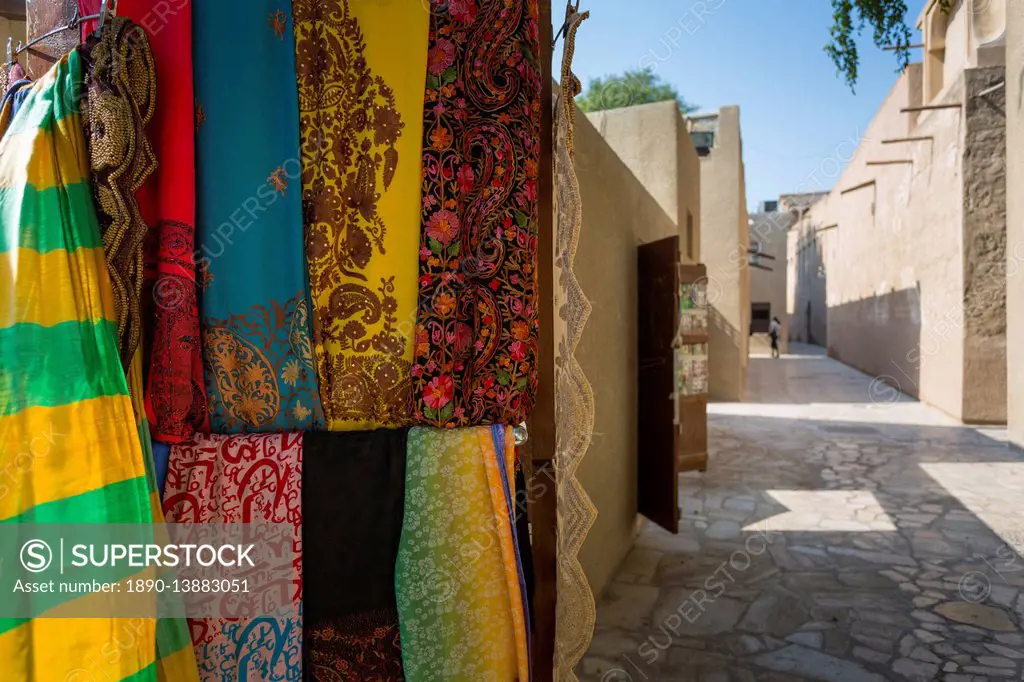 Narrow street and fabric shop in Al Fahidi Historical Centre, Bur Dubai, Dubai, United Arab Emirates, Middle East