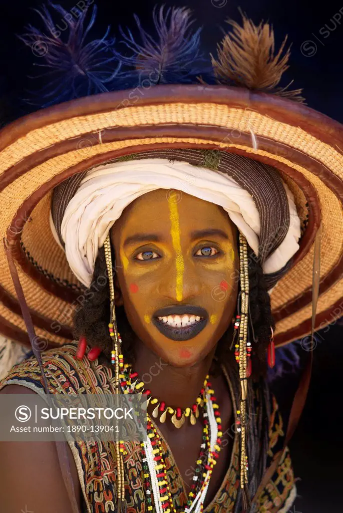 Wodaabe Bororo man with his face painted at the annual Gerewol male beauty contest, a general reunion of West African Wodaabe Peuls Bororo Peul, Niger...