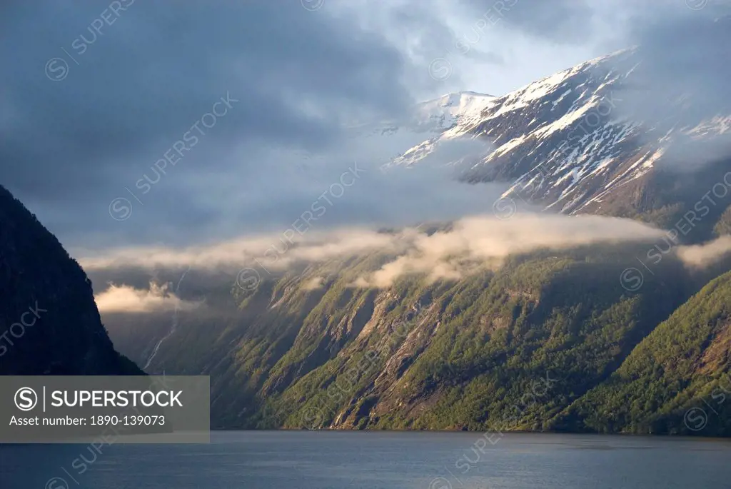 Clouds hang in the narrow entrance from the Sunnylvsfjord and the Storfjord, Geiranger Fjord, UNESCO World Heritage Site, west coast, Norway, Scandina...