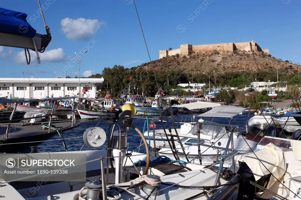Fishing boats in the harbour and the 6th century Byzantine Fortress in the background, Kelibia, Tunisia, North Africa, Africa