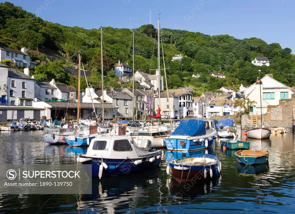 Boats and cottages surround the pretty harbour in the fishing village of Polperro, Cornwall, England, United Kingdom, Europe