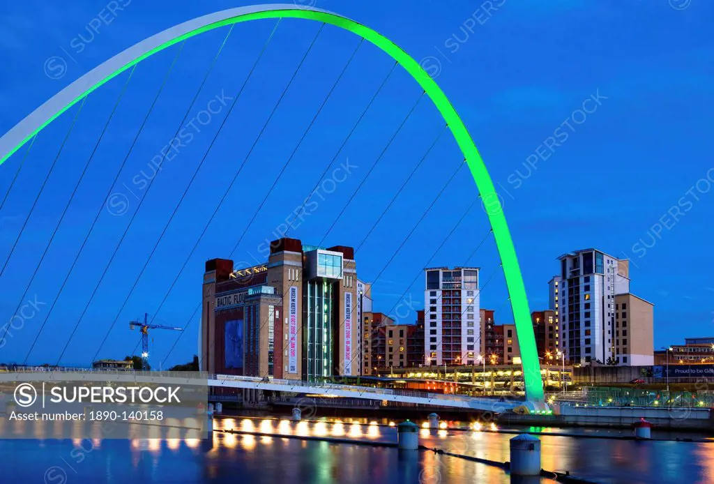 View along the Quayside at night showing the Baltic Centre for Contemporary Arts framed by the floodlit Gateshead Millennium Bridge, Newcastle_upon_Ty...