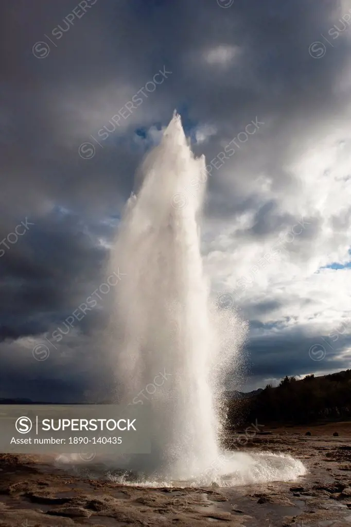 Water spout from Strokkur Geysir exploding into the sky on a stormy evening, near Reykjavik, Iceland, Polar Regions