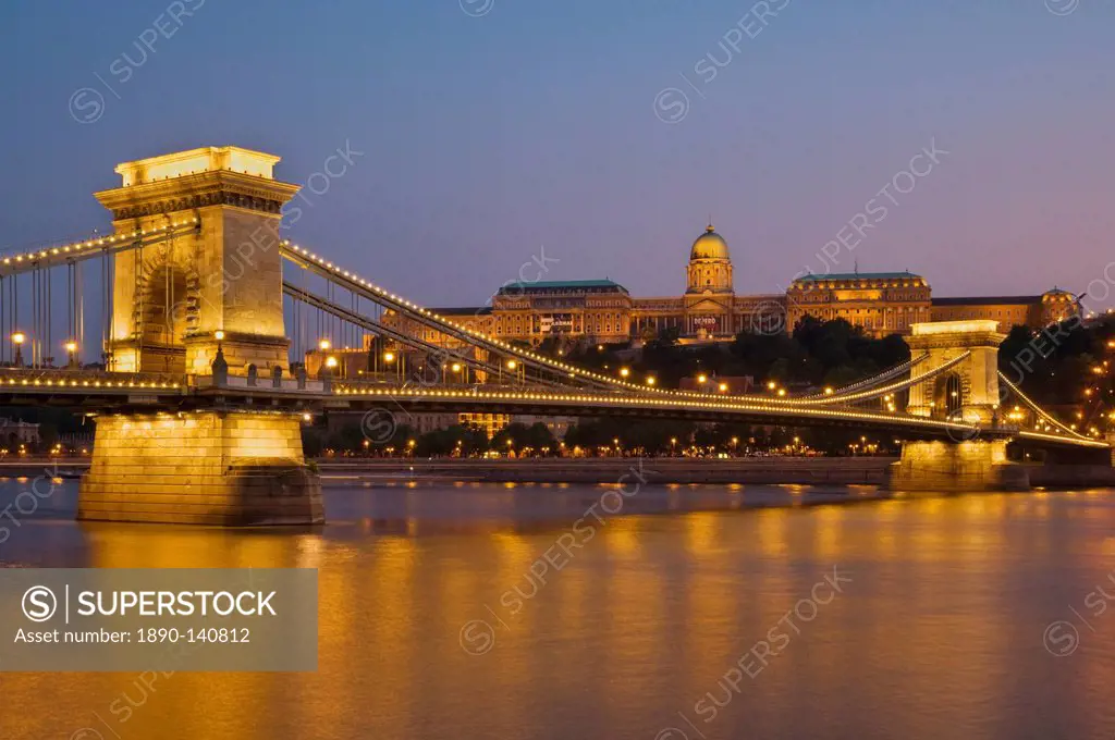 The Chain Bridge Szechenyi Lanchid, over the River Danube, illuminated at sunset with the Hungarian National Gallery behind, UNESCO World Heritage Sit...