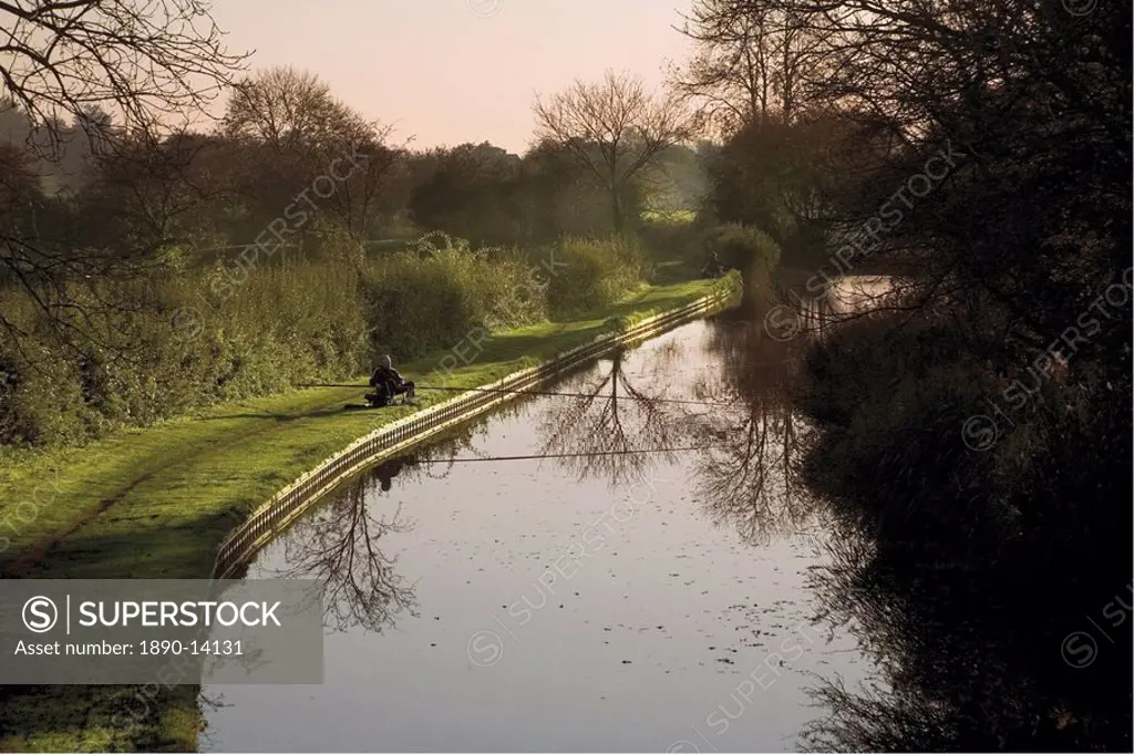 Man fishing from the towpath, Worcester and Birmingham canal, Hanbury, Worcestershire, Midlands, England, United Kingdom, Europe