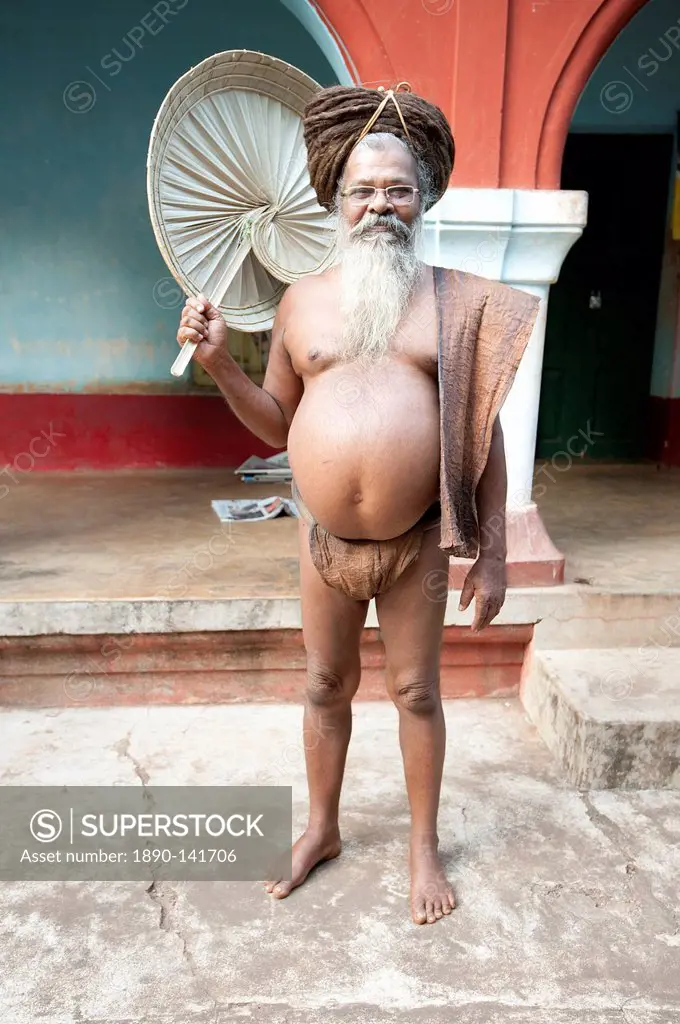 Joranda monk wearing tree bark loincloth, holding palm leaf fan, with uncut hair piled up on top of his head, Joranda, Orissa, India, Asia