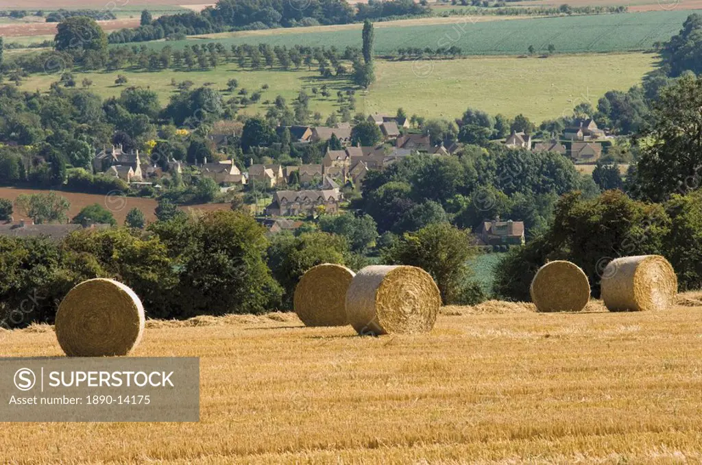Bales of hay with Chipping Campden beyond, from the Cotswolds Way footpath, The Cotswolds, Gloucestershire, England, United Kingdom, Europe