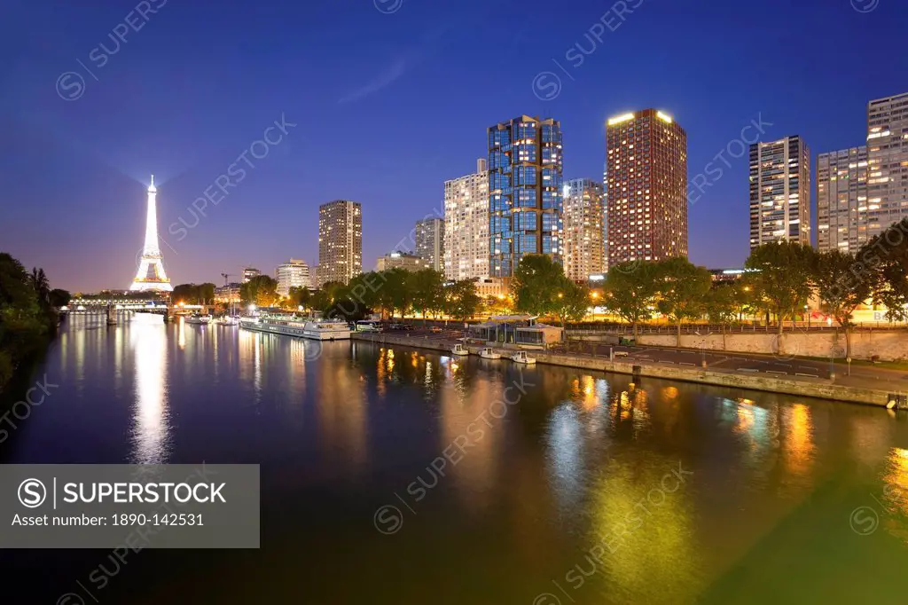 Night view of River Seine with high_rise buildings on the Left Bank, and Eiffel Tower, Paris, France, Europe