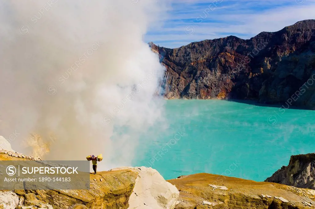 Sulphur worker appearing out of toxic fumes at Kawah Ijen, East Java, Indonesia, Southeast Asia, Asia