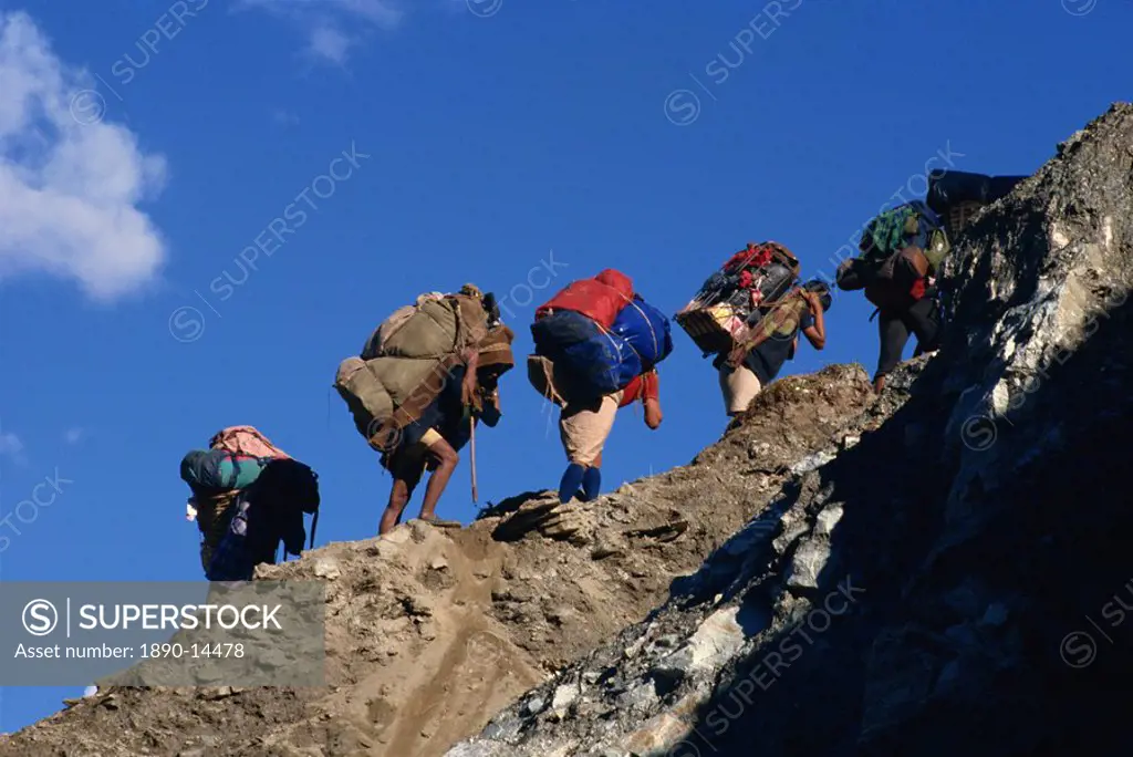 Trek porters on eroded trail to Ghorapani Pass near Chitre, Nepal, Asia