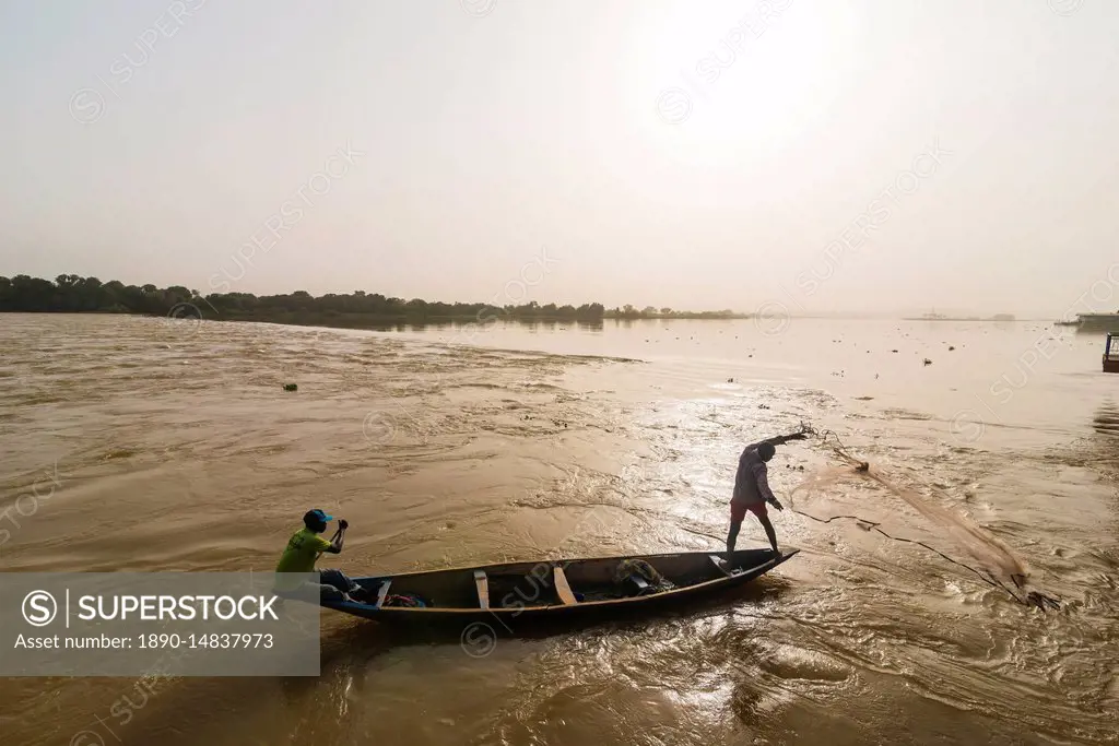 Fisherman throwing his fishing net into the River Niger, Niamey