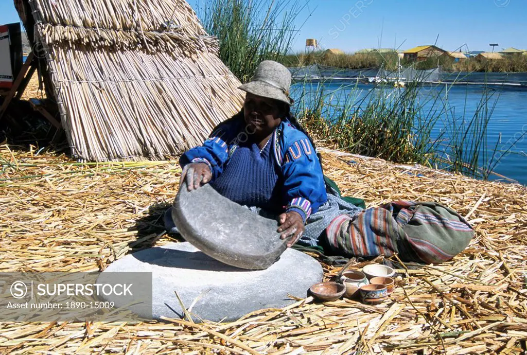 Uros Urus woman grinding corn, Islas Flotantas, reed islands, Lake Titicaca, Peru, South America