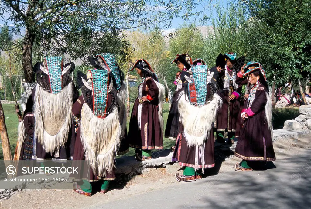 Ladakhi women in traditional clothing, yak_skin coat and turquoise head dress, Ladakh, India, Asia