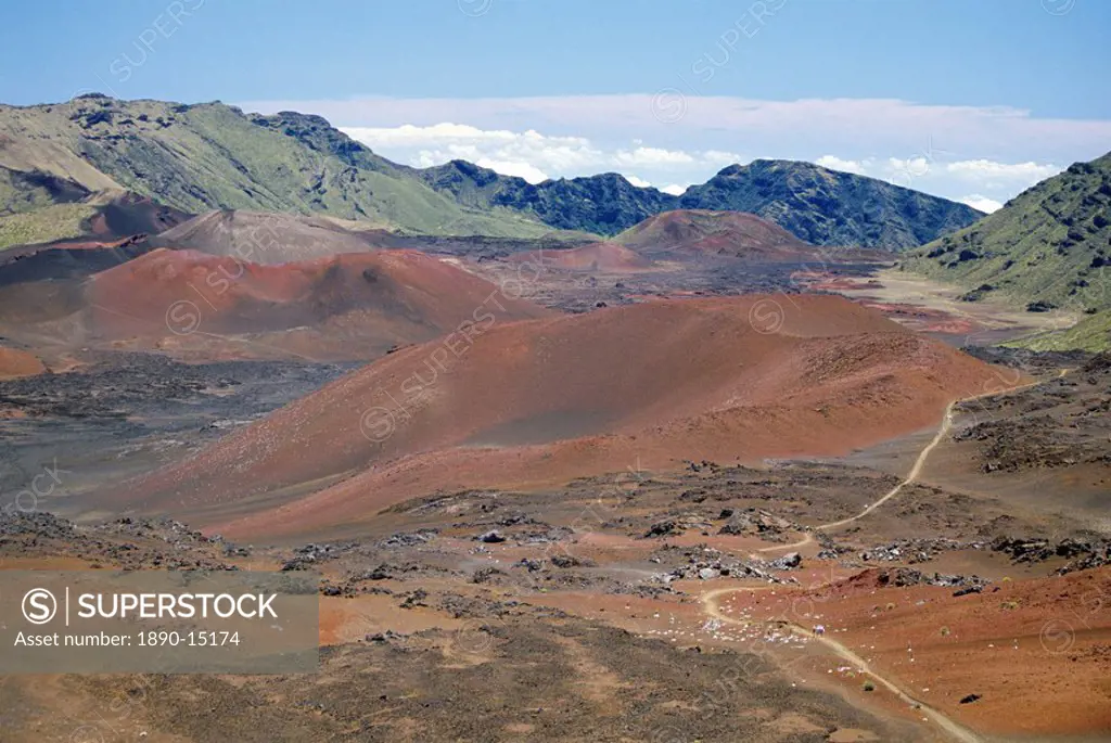 Foot trail through Haleakala volcano crater winds between red cinder cones, Haleakala National Park, Maui, Hawaii, Hawaiian Islands, United States of ...