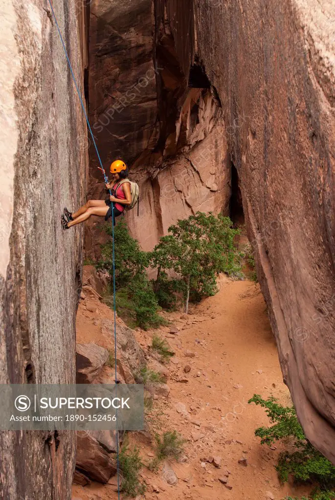 Tourist hanging on a rope while Canyoning in the area of the Slickrock Trail, near Arches National Park, Moab, Utah, United States of America, North A...