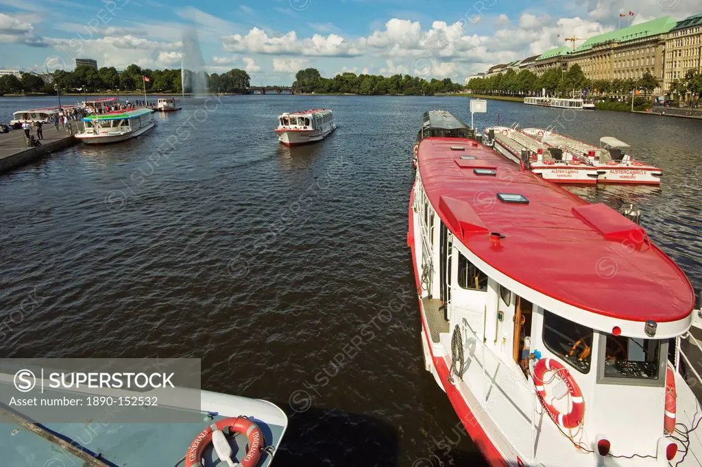 Tour boats that ply the popular Alster Lake moored at the Jungfernstieg with the Ballindamm beyond, Hamburg, Germany, Europe