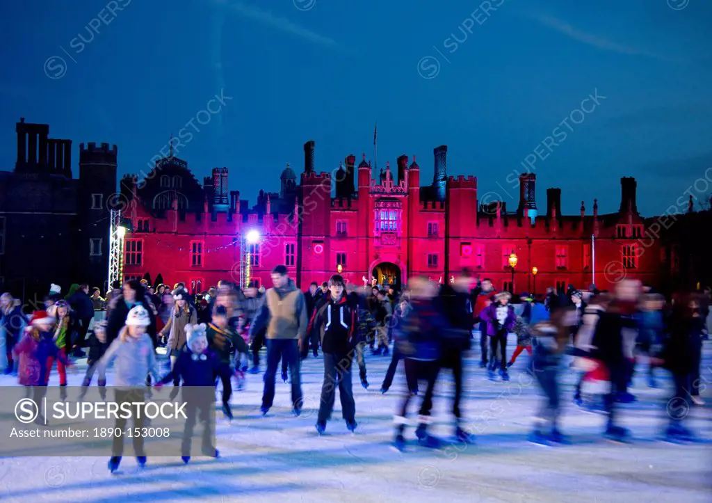 A skating rink in front of Hampton Court Palace lit with red lights, Greater London, England, United Kingdom, Europe