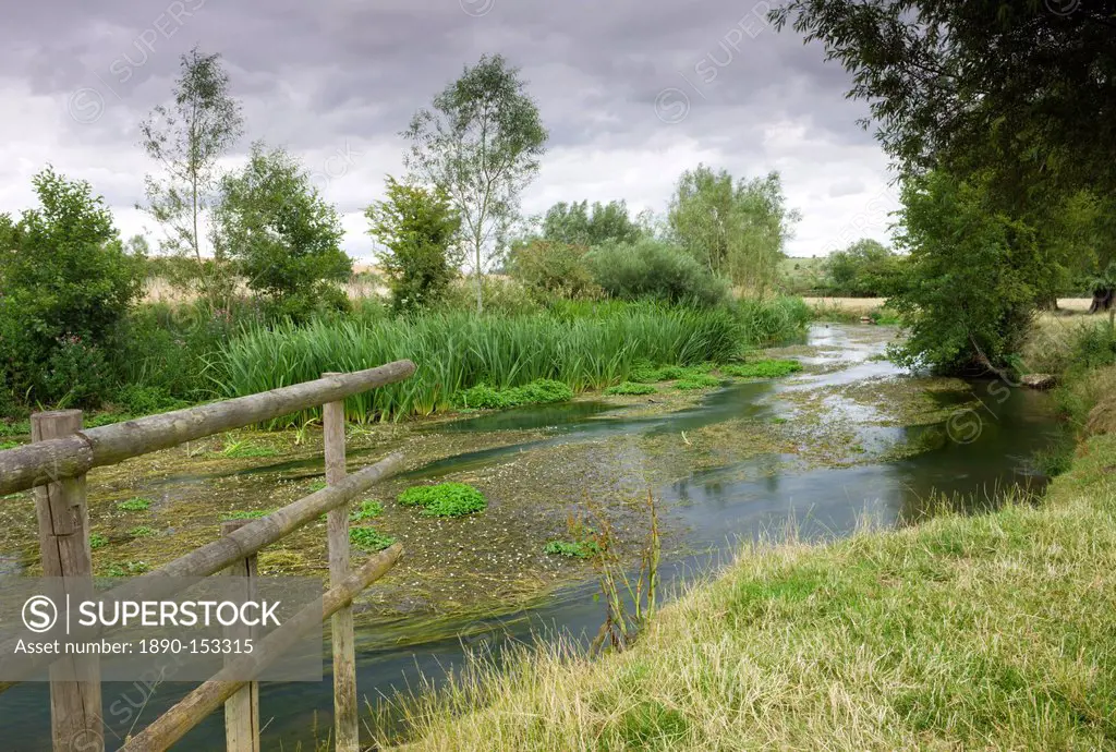 The River Windrush meandering through countryside near Burford in the Cotswolds, Oxfordshire, England, United Kingdom, Europe