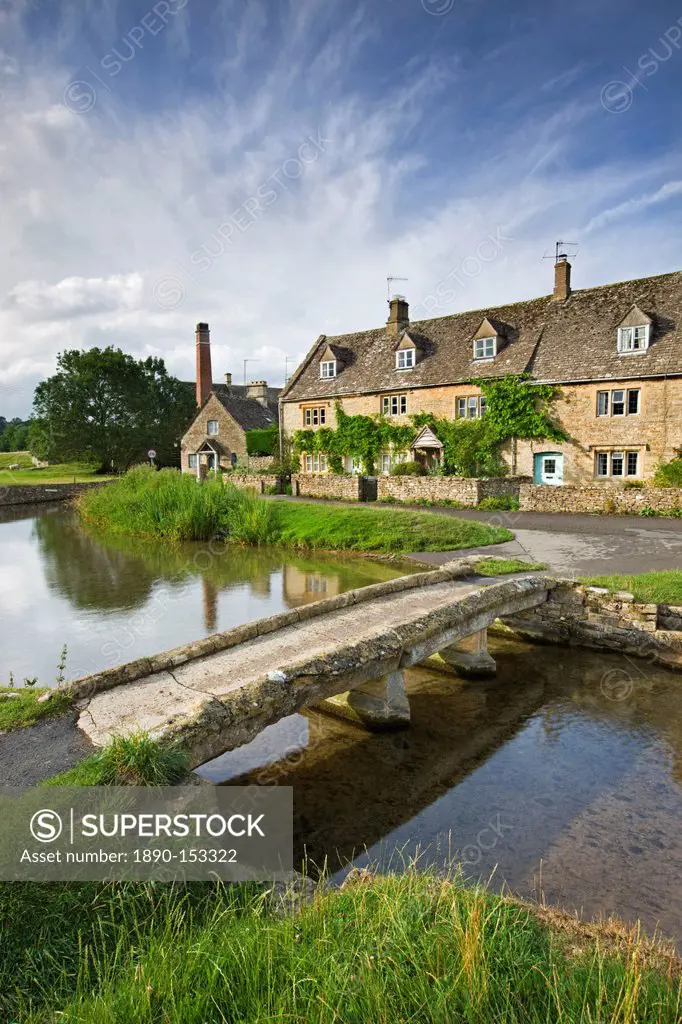 Stone footbridge and cottages at Lower Slaughter in the Cotswolds, Gloucestershire, England, United Kingdom, Europe