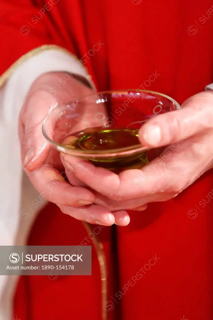 Catholic priest holding sacred oil, Seine_Saint_Denis, France, Europe
