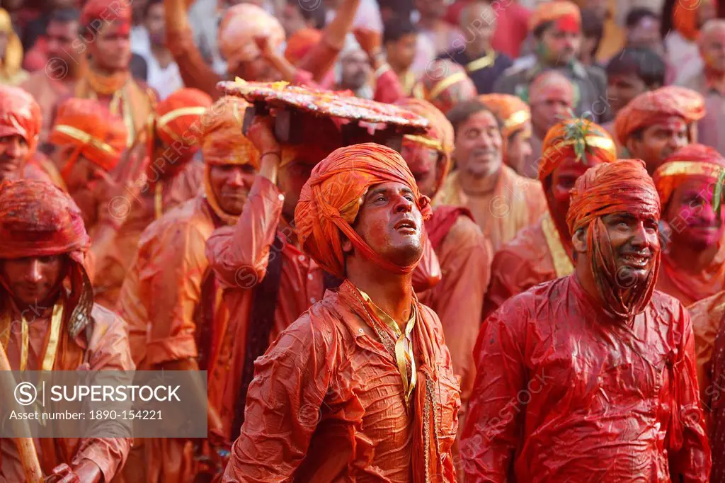 Barsana villagers celebrating Holi in Nandgaon, taunting Nandgaon villagers who throw colored fluids over them, Nandgaon, Uttar Pradesh, India, Asia