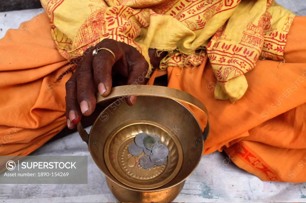 Holy man begging outside a temple, Vrindavan, Uttar Pradesh, India, Asia