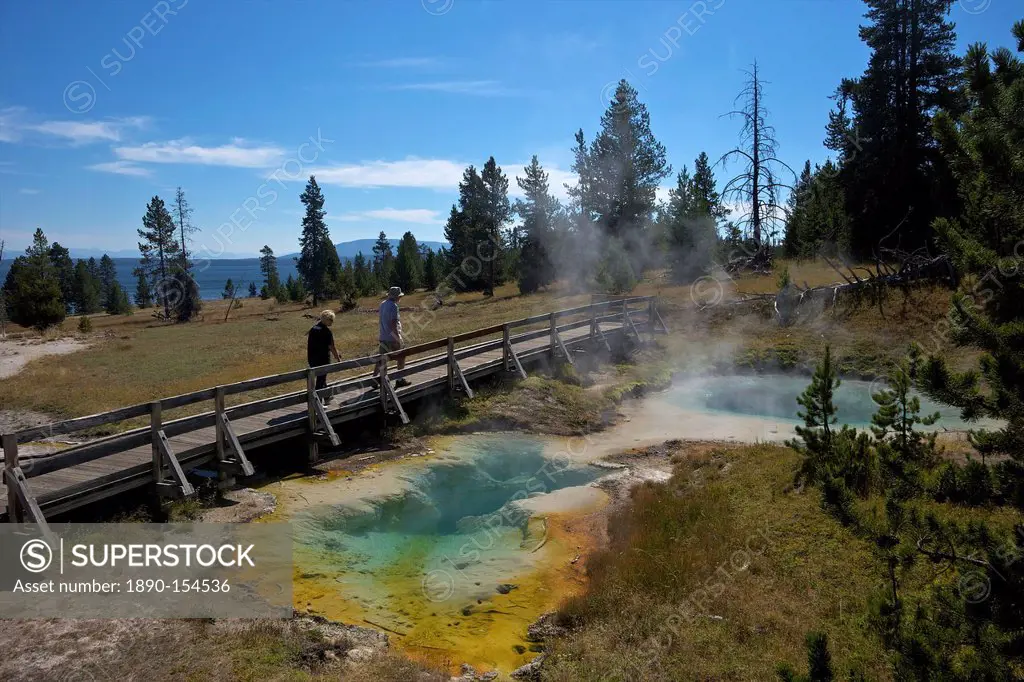 Tourists looking at Seismograph and Bluebell pools, West Thumb Geyser Basin, Yellowstone National Park, UNESCO World Heritage Site, Wyoming, United St...
