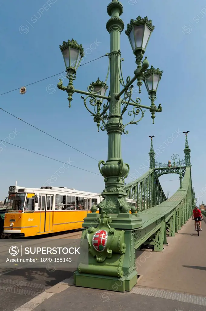 Tram and cyclist on Independence Bridge spanning Danube River, Budapest, Hungary, Europe