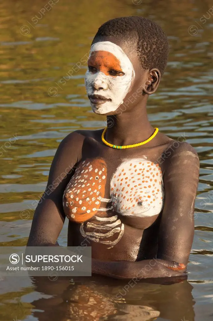 Young Surma woman with body paintings in the river, Kibish, Omo River Valley, Ethiopia, Africa